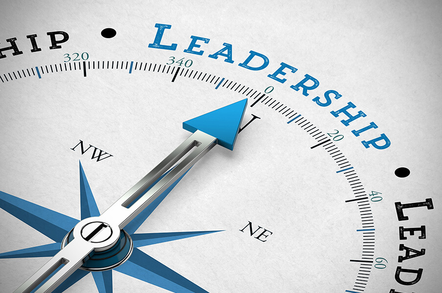 A still life photo of a compass with the arrow pointing to "Leadership"