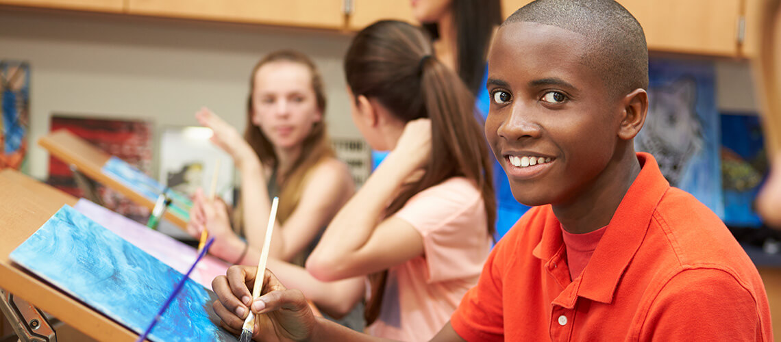 An art class with 3 youth painting