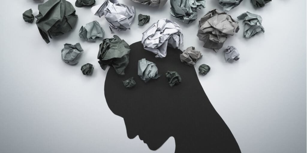 silhouette with crumpled papers representing health anxiety