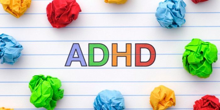 colourful letters spelling ADHD with crumpled paper