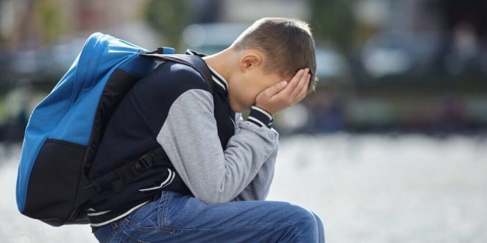 anxious child showing signs of school refusal