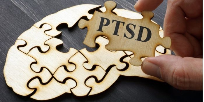 wooden puzzle of human brain with PTSD on one piece need for CBT for PTSD