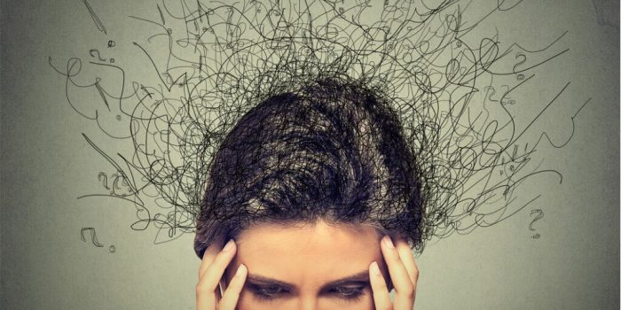 person holding head with many imposing thoughts need for CBT for OCD and GAD