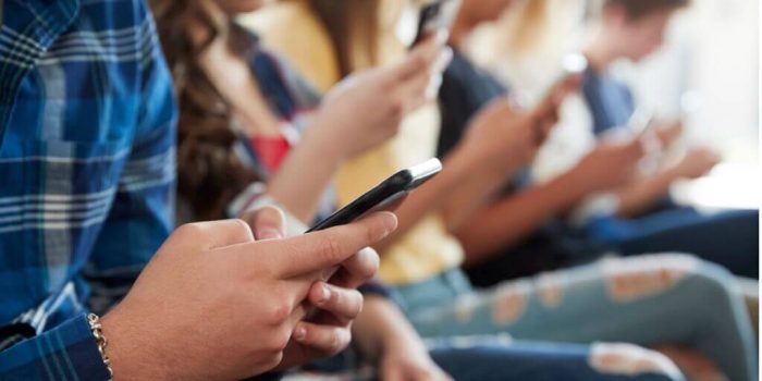 youth on phones accessing digital media
