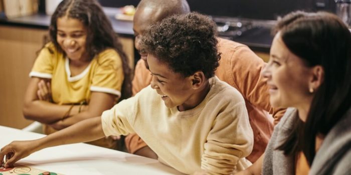 family playing a game together - skills for child-focused family therapy