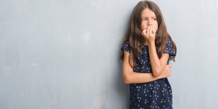 Child biting nails looking anxious/worried