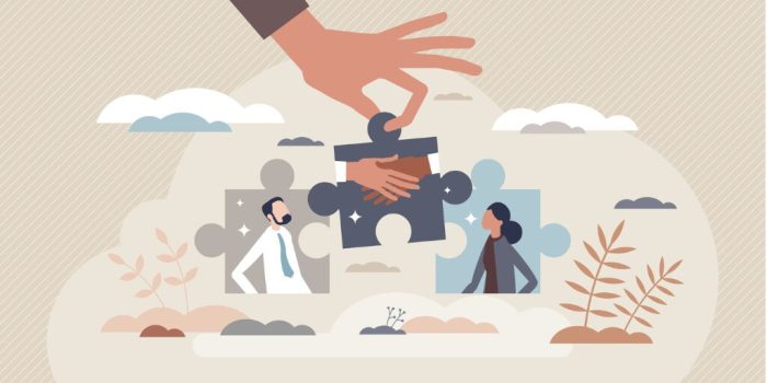 image of two separate puzzle pieces with a hand holding the connector piece for conflict management skills
