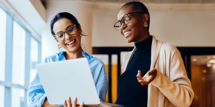two professionals in a warm, focused workplace interaction for resilience training for leaders
