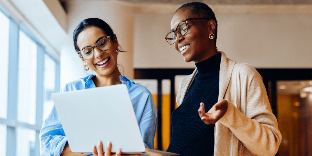 two professionals in a warm, focused workplace interaction for resilience training for leaders