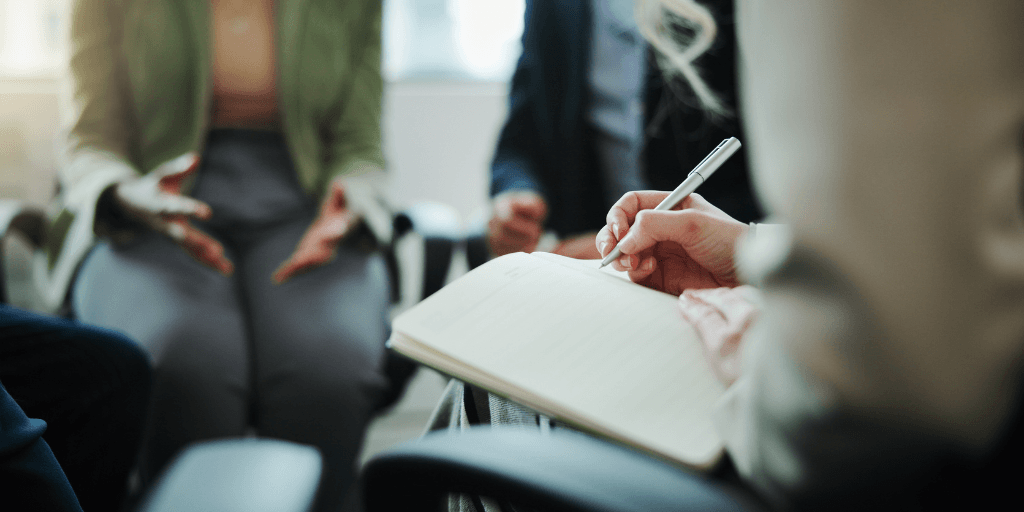 therapy session with professional taking notes for Stabilization, trauma assessment, and treatment planning